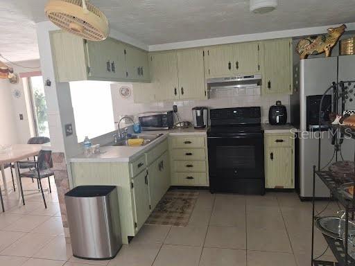 3600 Darlington Road Holiday, FL 34691 - Photo 8 of 20 a kitchen with cabinets and appliances
