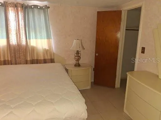 a bedroom with a bed and a gate