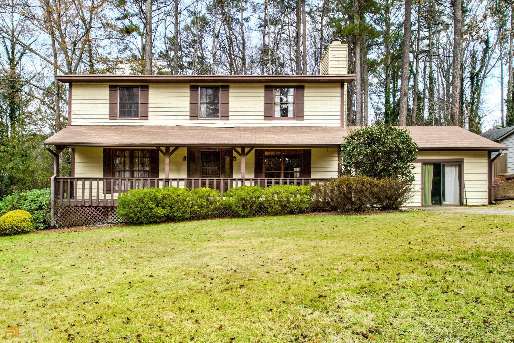 208 Swanson Ridge Peachtree City, GA 30269 - Photo 1 of 1 a front view of a house with yard and green space