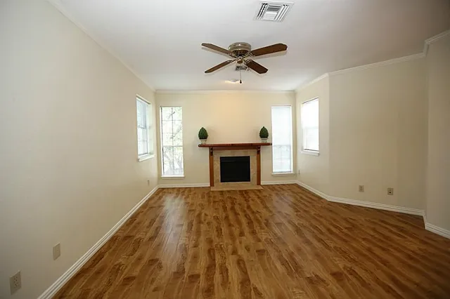 wooden floor in an empty room with a fireplace