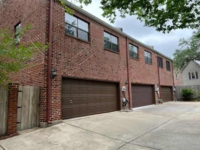 a front view of a house with a garage and a yard