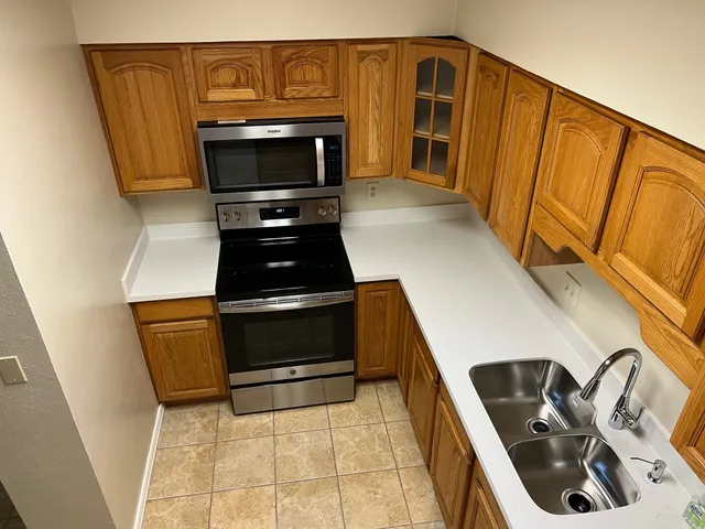 a kitchen with a sink and a stove top oven