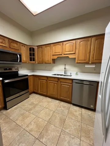 a kitchen with stainless steel appliances granite countertop a sink and cabinets