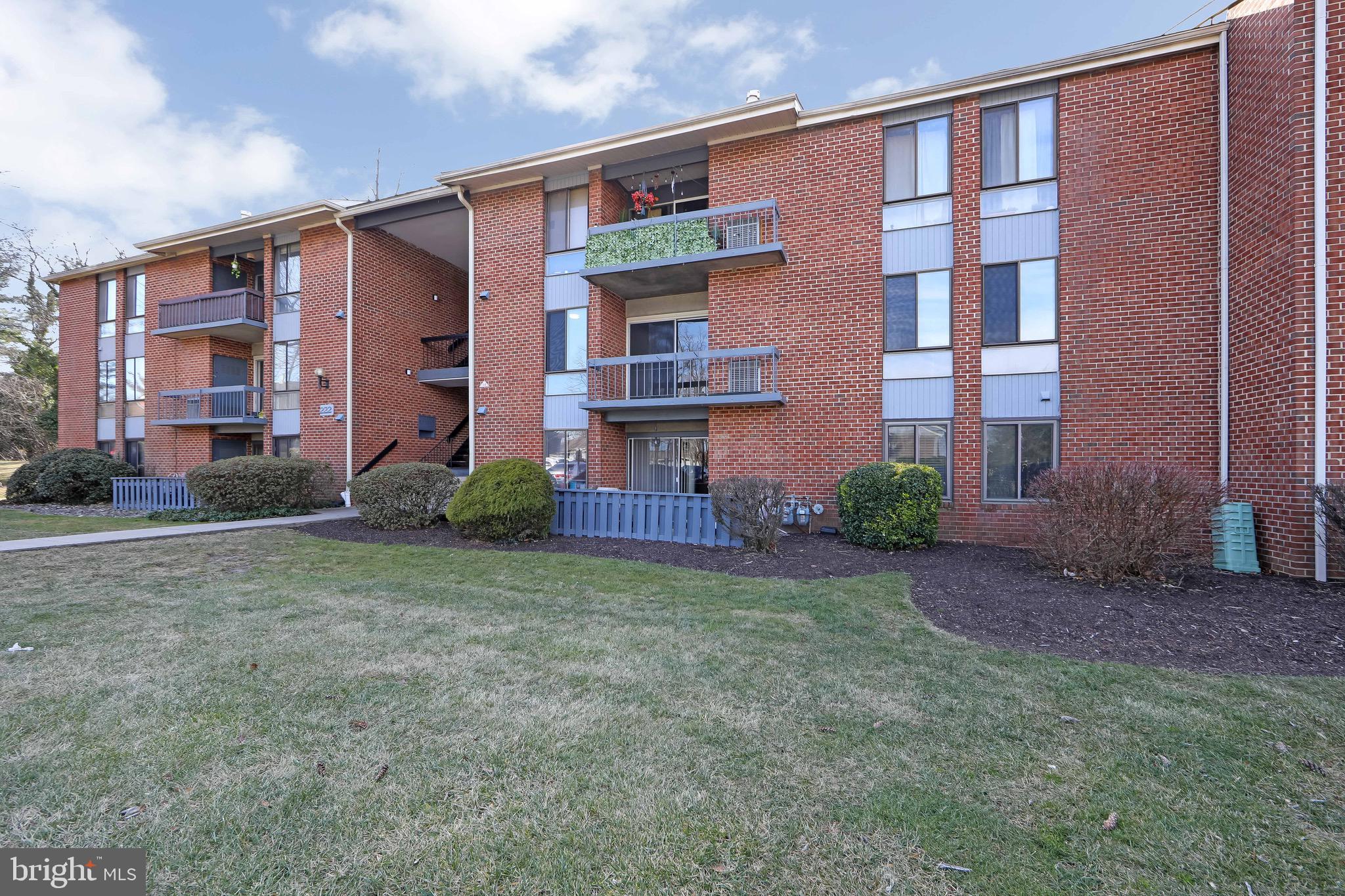 222 Echelon Road Voorhees, NJ 08043 - Photo 27 of 29 a view of a brick building next to a yard