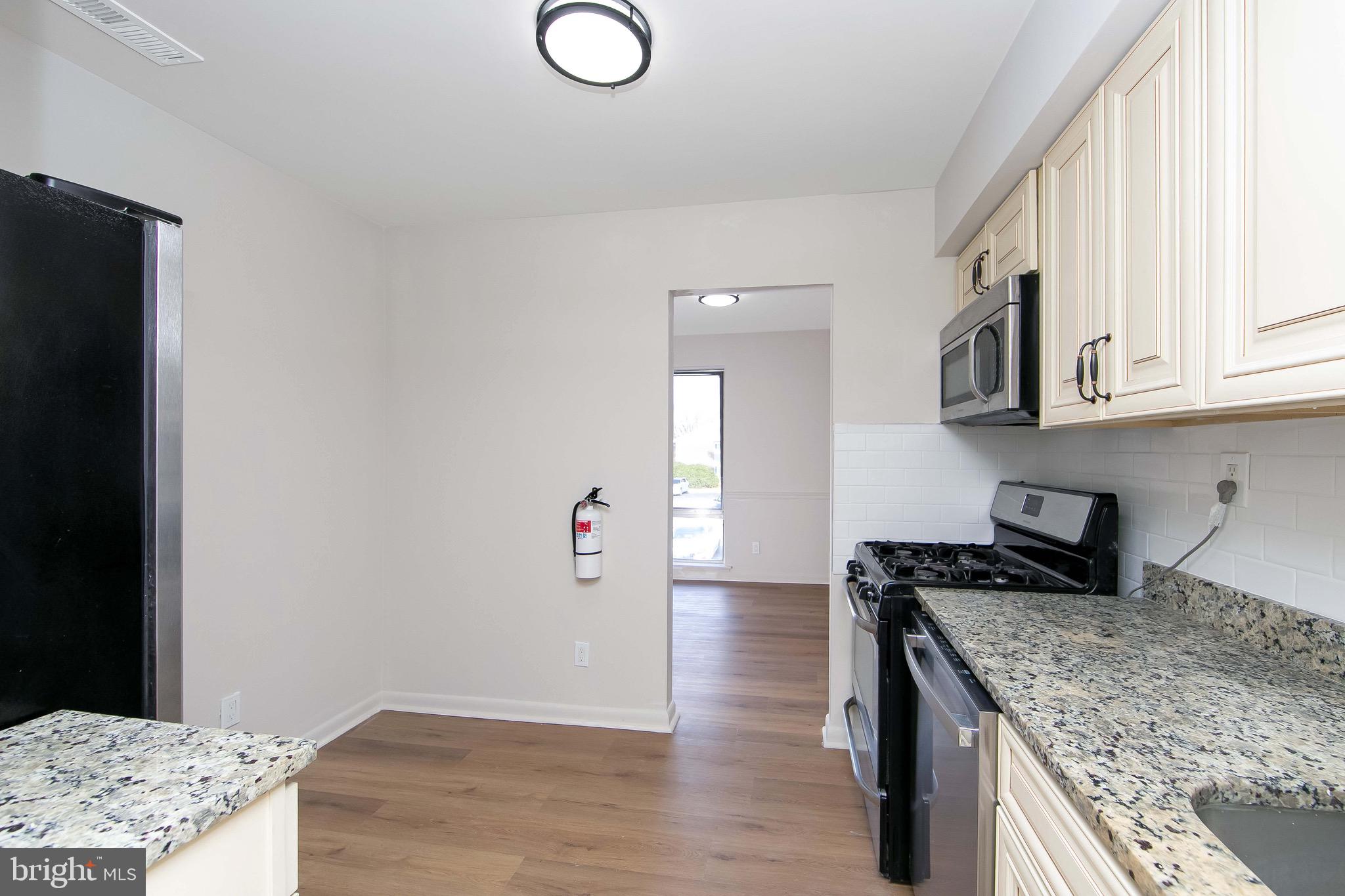 222 Echelon Road Voorhees, NJ 08043 - Photo 4 of 29 a kitchen with granite countertop a sink a stove and cabinets