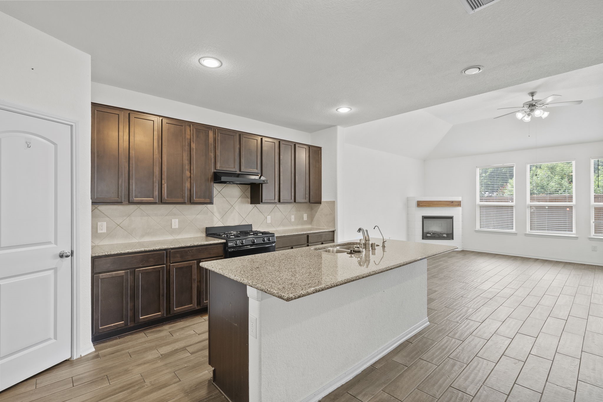 903 Willowick Road Houston, TX 77090 - Photo 3 of 47 The kitchen anchors the first floor with granite countertops, a large island, breakfast bar seating, gas cooking, and pantry storage. Its open connection to the family room keeps the main level bright and practical.