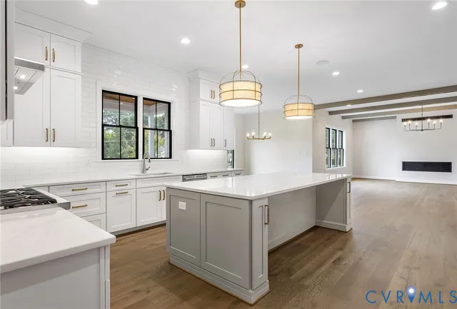 a view of an empty room with a window and fireplace
