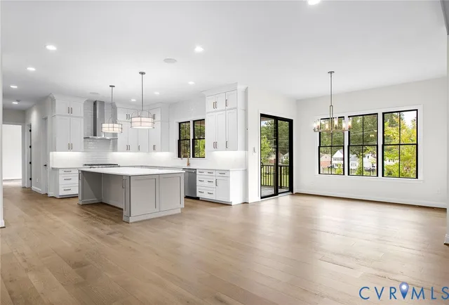an empty room with wooden floor and balcony