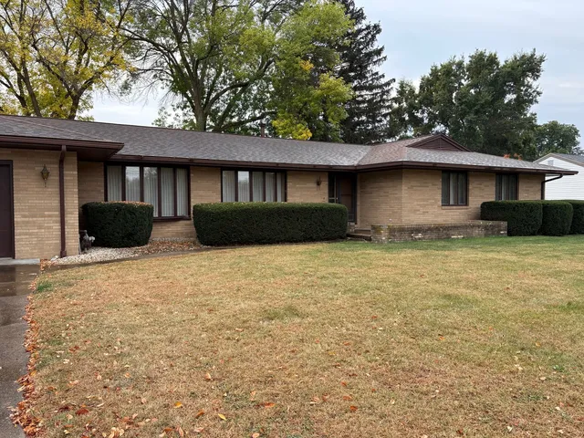 a house that has a tree in front of it