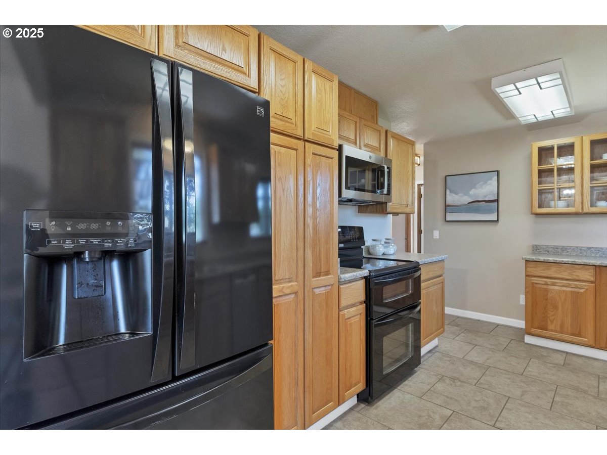 224 South 24th Street Philomath, OR 97370 - Photo 20 of 46 a kitchen with stainless steel appliances granite countertop a refrigerator and a stove