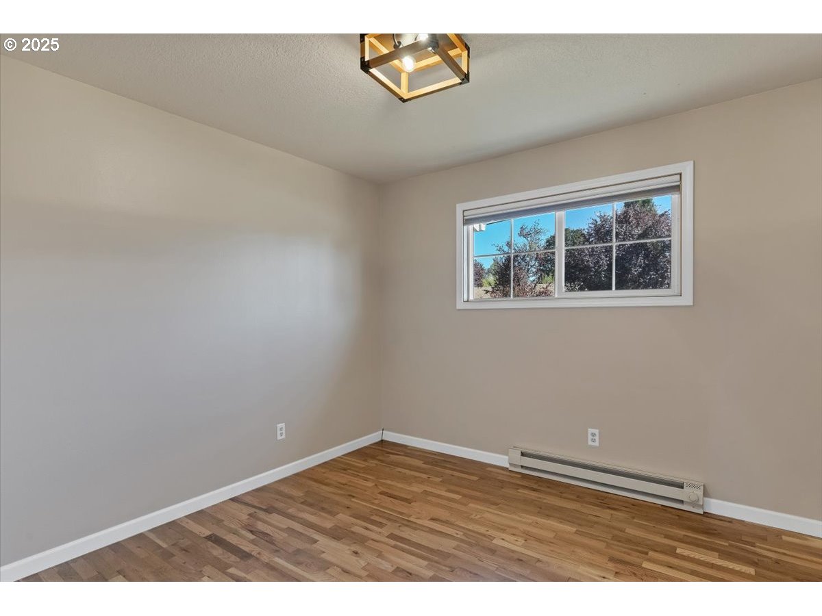 224 South 24th Street Philomath, OR 97370 - Photo 24 of 46 an empty room with wooden floor and window