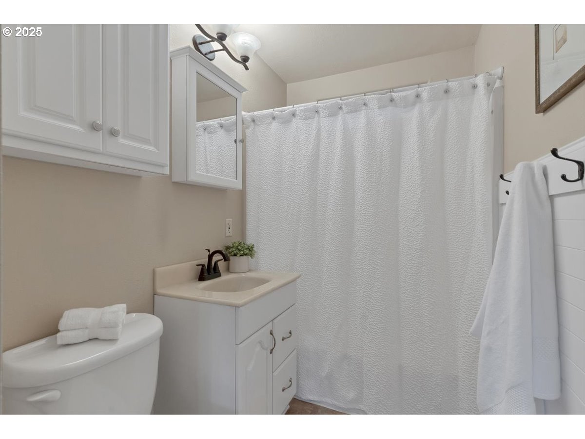 224 South 24th Street Philomath, OR 97370 - Photo 31 of 46 a bathroom with a sink vanity and a mirror