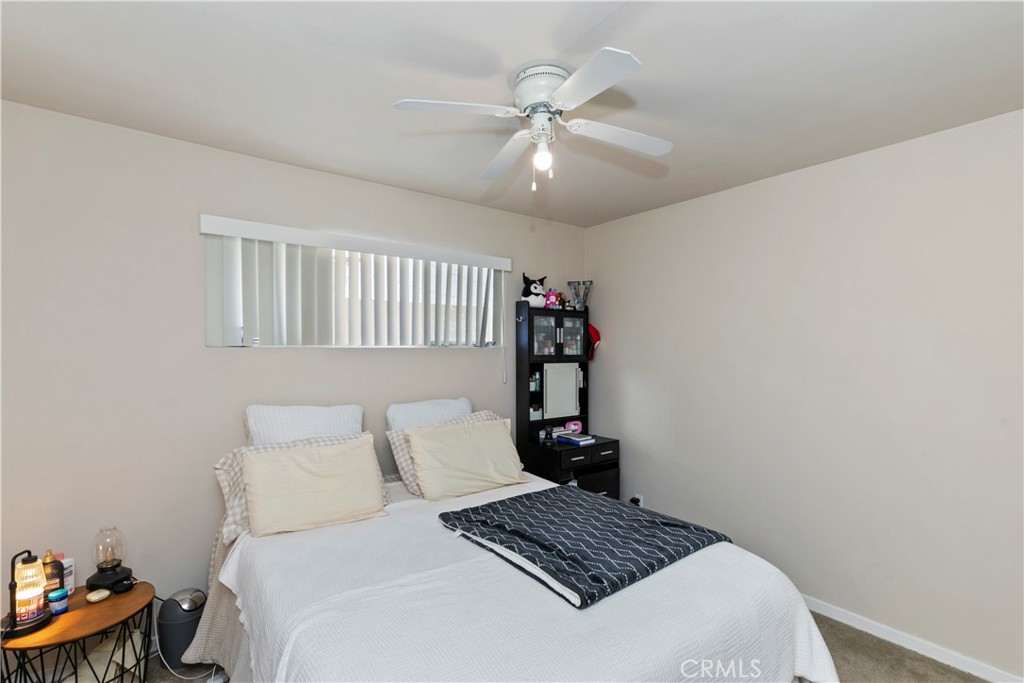 114 Juniper Street Brea, CA 92821 - Photo 16 of 64 a bedroom with a bed and a table with lamp