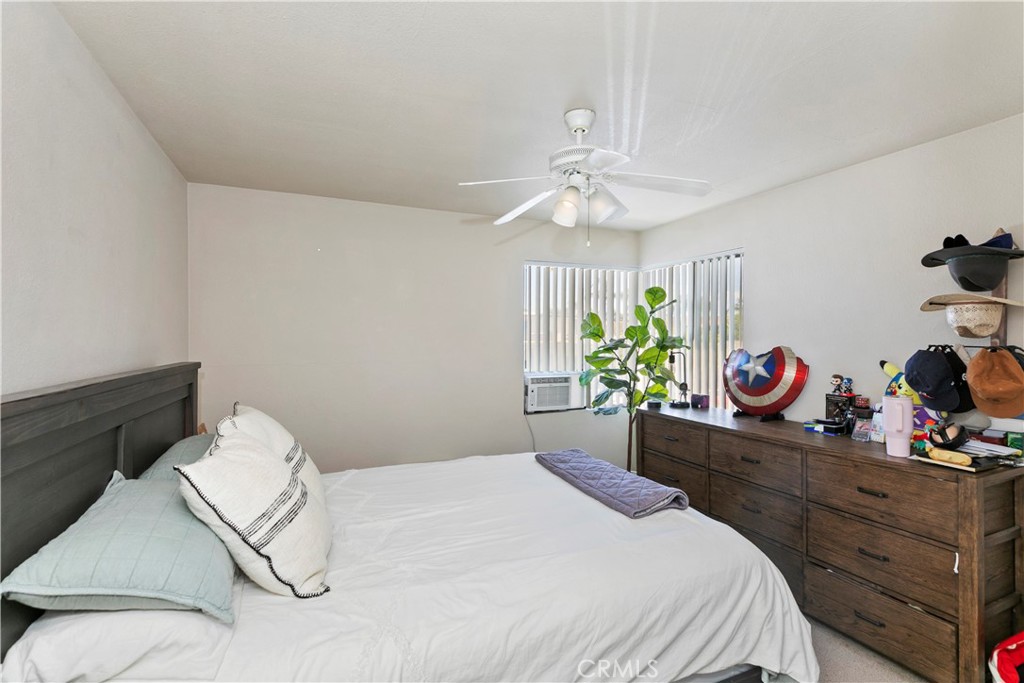 114 Juniper Street Brea, CA 92821 - Photo 30 of 64 a bedroom with a bed and a chandelier