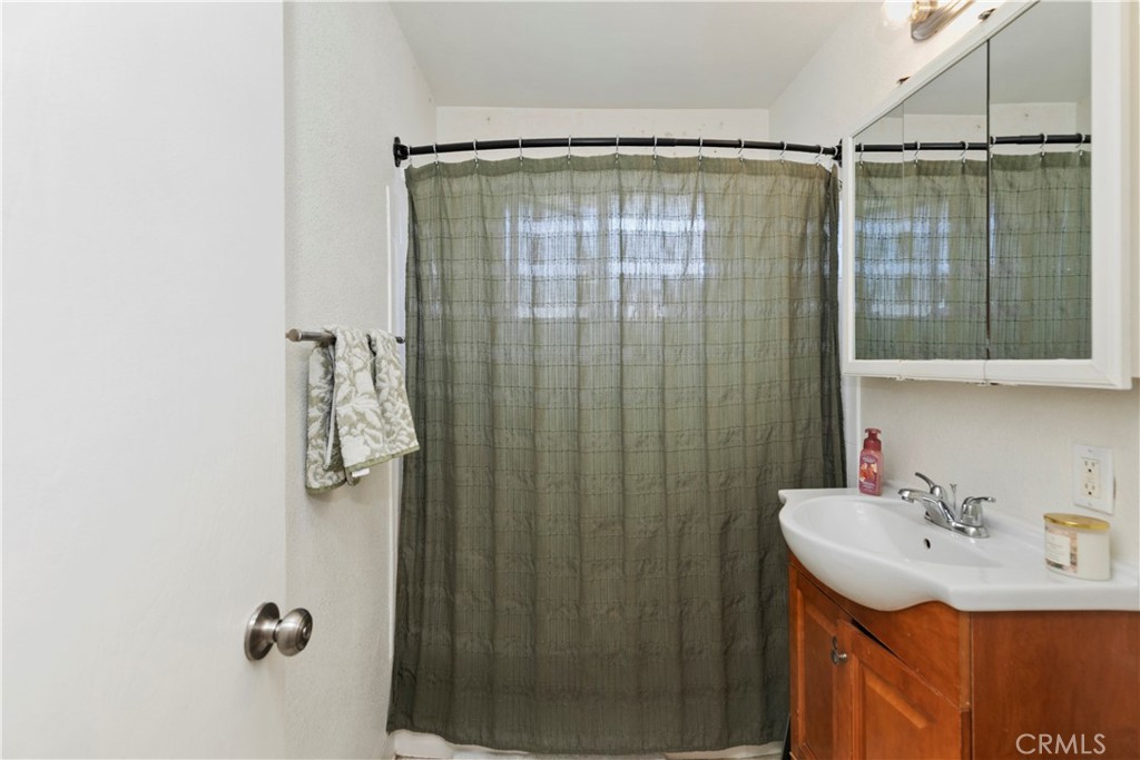114 Juniper Street Brea, CA 92821 - Photo 31 of 64 a bathroom with a shower curtain and a sink