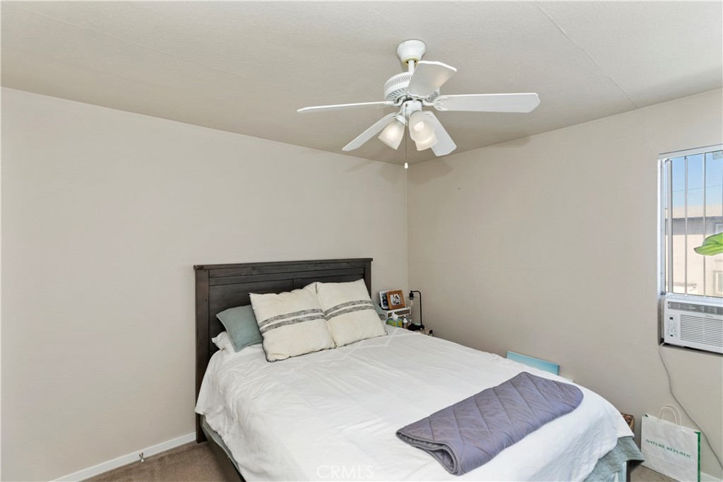 114 Juniper Street Brea, CA 92821 - Photo 32 of 64 a bedroom with a bed and a chandelier