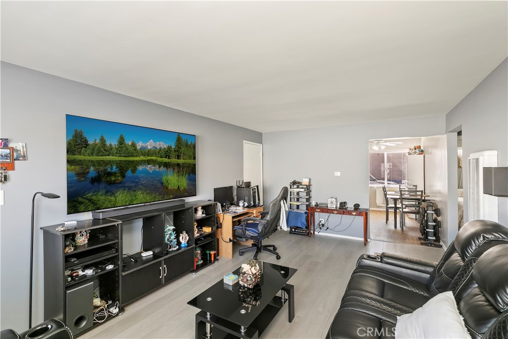 114 Juniper Street Brea, CA 92821 - Photo 37 of 64 a living room with furniture a flat screen tv and a floor to ceiling window