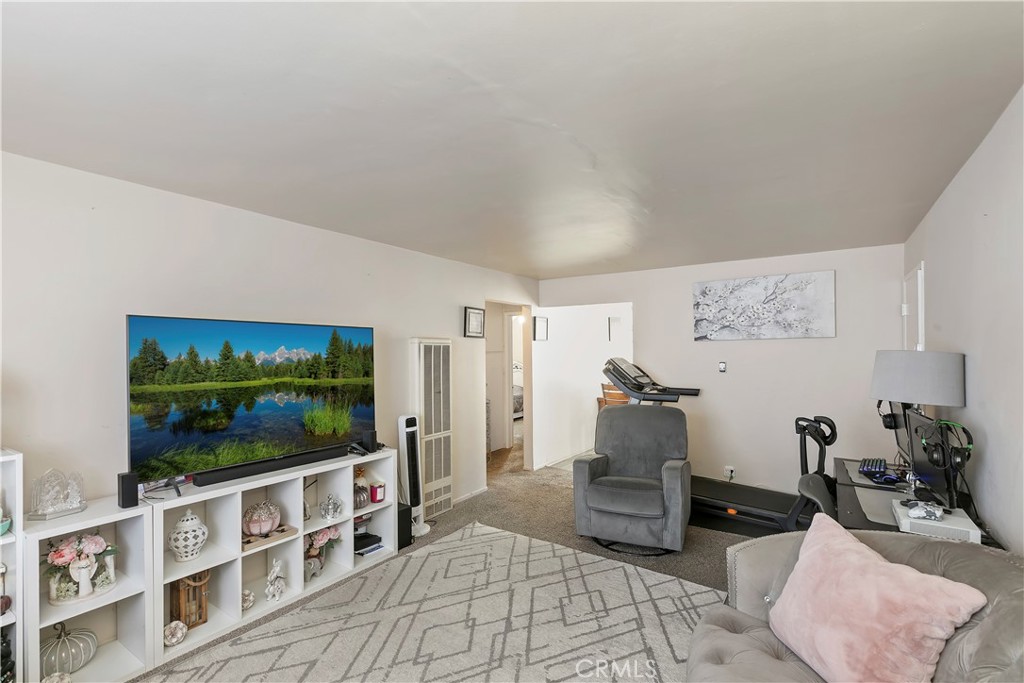 114 Juniper Street Brea, CA 92821 - Photo 46 of 64 a living room with furniture a flat screen tv and a floor to ceiling window