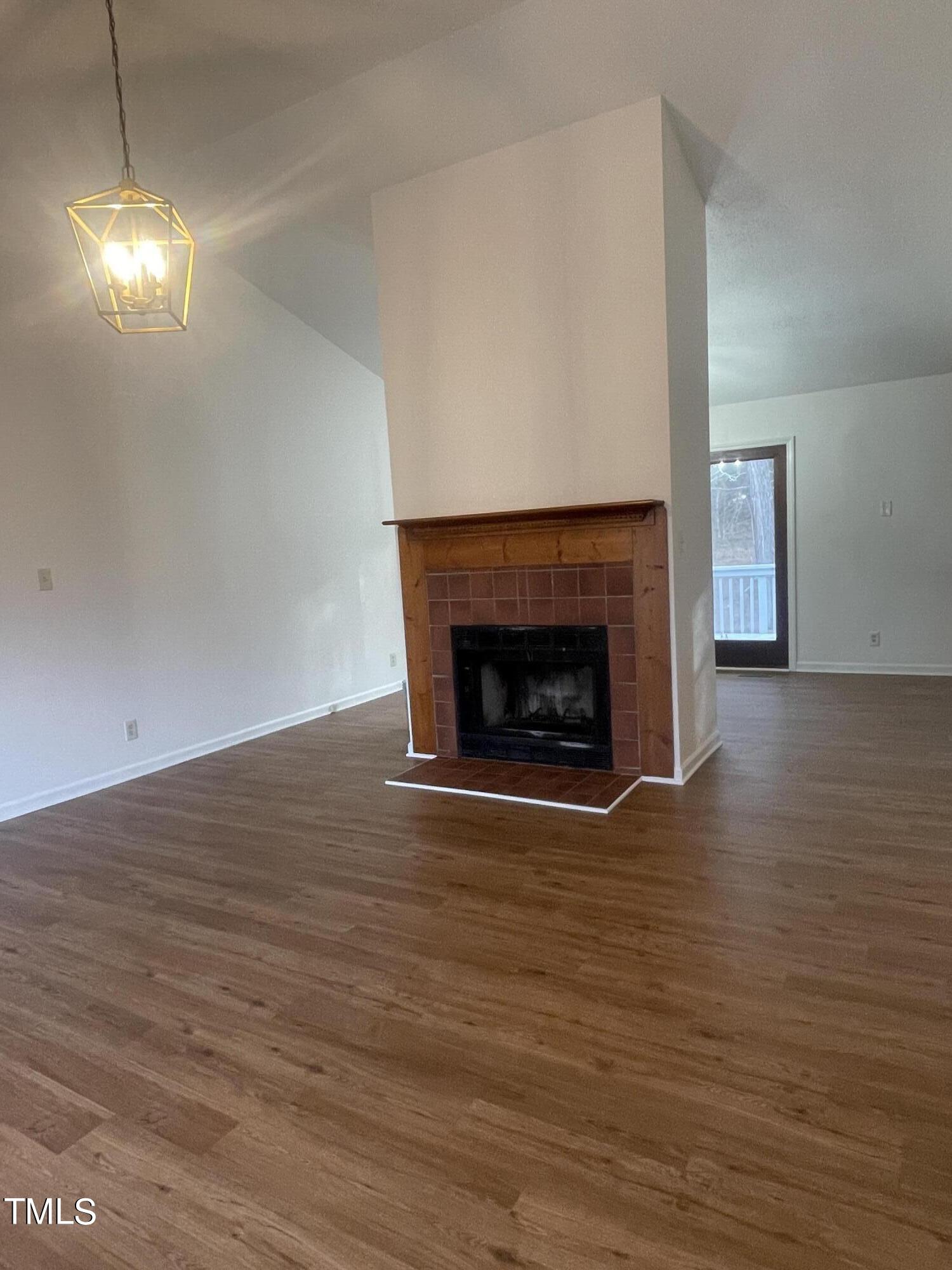 1015 Horton Road Durham, NC 27704 - Photo 13 of 15 a room with a fireplace and a fireplace