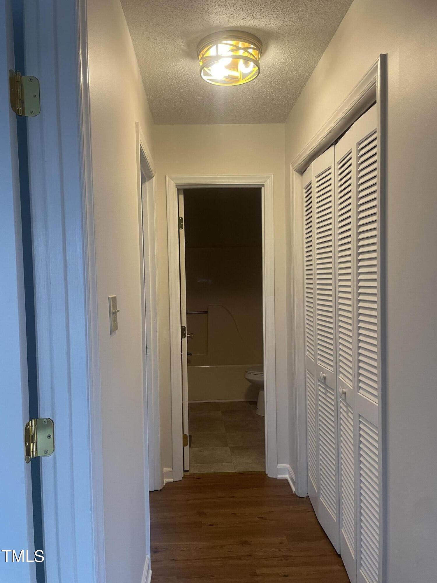 1015 Horton Road Durham, NC 27704 - Photo 7 of 15 a view of a hallway with wooden floor