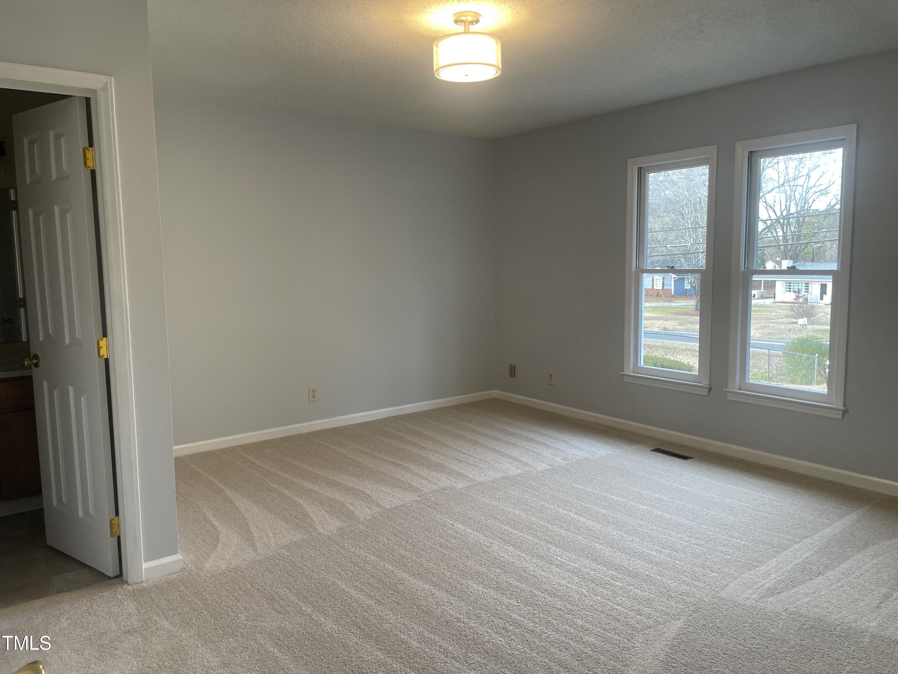 1015 Horton Road Durham, NC 27704 - Photo 9 of 15 an empty room with windows