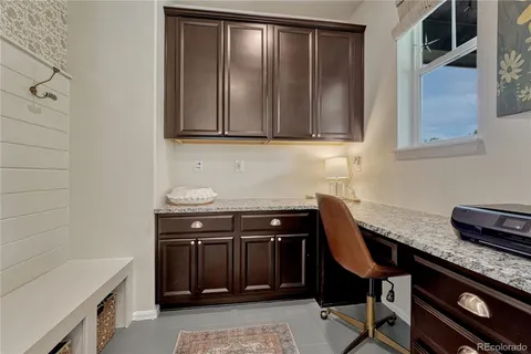 a kitchen with granite countertop a sink a stove and cabinets