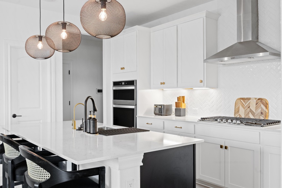 400 Turnbuckle Bend Leander, TX 78641 - Photo 12 of 40 a kitchen with a refrigerator a stove and white cabinets