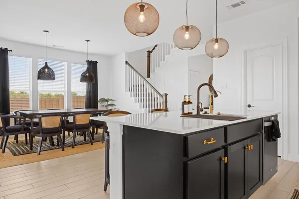 a kitchen with a table and chairs