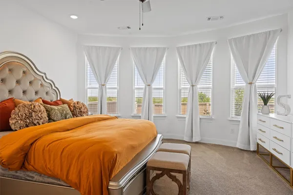 a bed sitting in a bedroom next to a window
