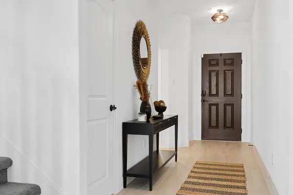 a bathroom with a sink a toilet a mirror and shower curtain
