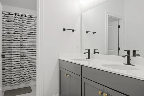 a bedroom with a bed and a flat tv screen on a dresser