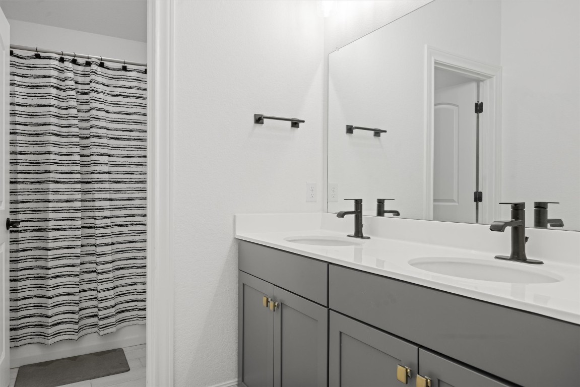 400 Turnbuckle Bend Leander, TX 78641 - Photo 34 of 40 a bathroom with a sink and a mirror