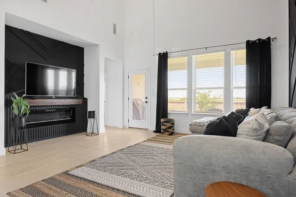 a spacious bedroom with a bed and a television