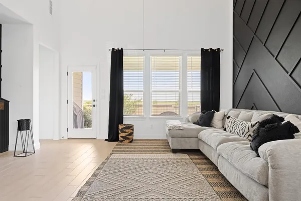 a living room with furniture and a large window