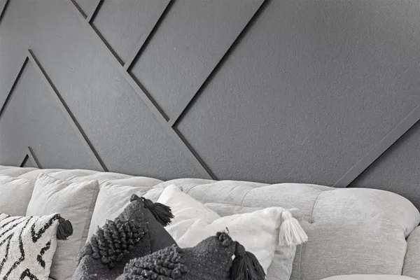 a bed with white sheets and pillows on it