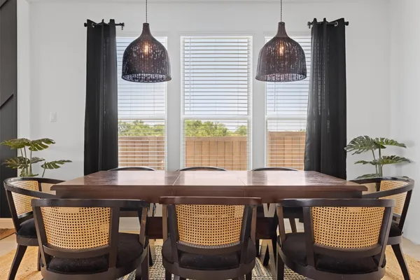 a view of a dining room with furniture and window