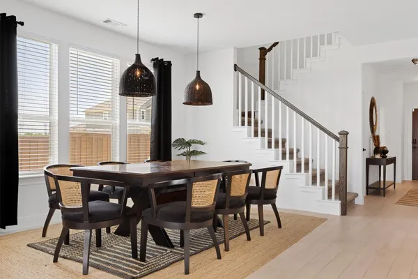 a dining room with furniture and window