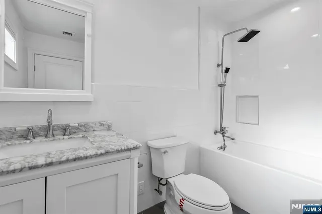 a bathroom with a bathtub a toilet and a shower