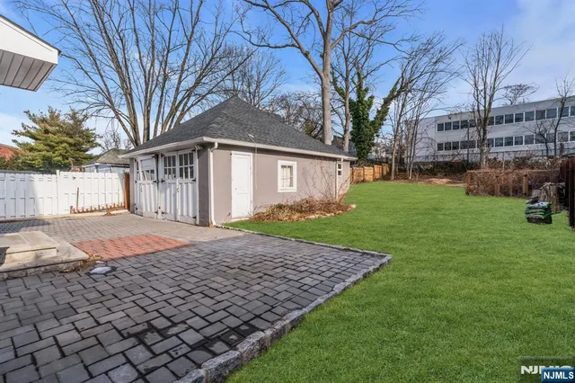 a backyard of a house with barbeque oven
