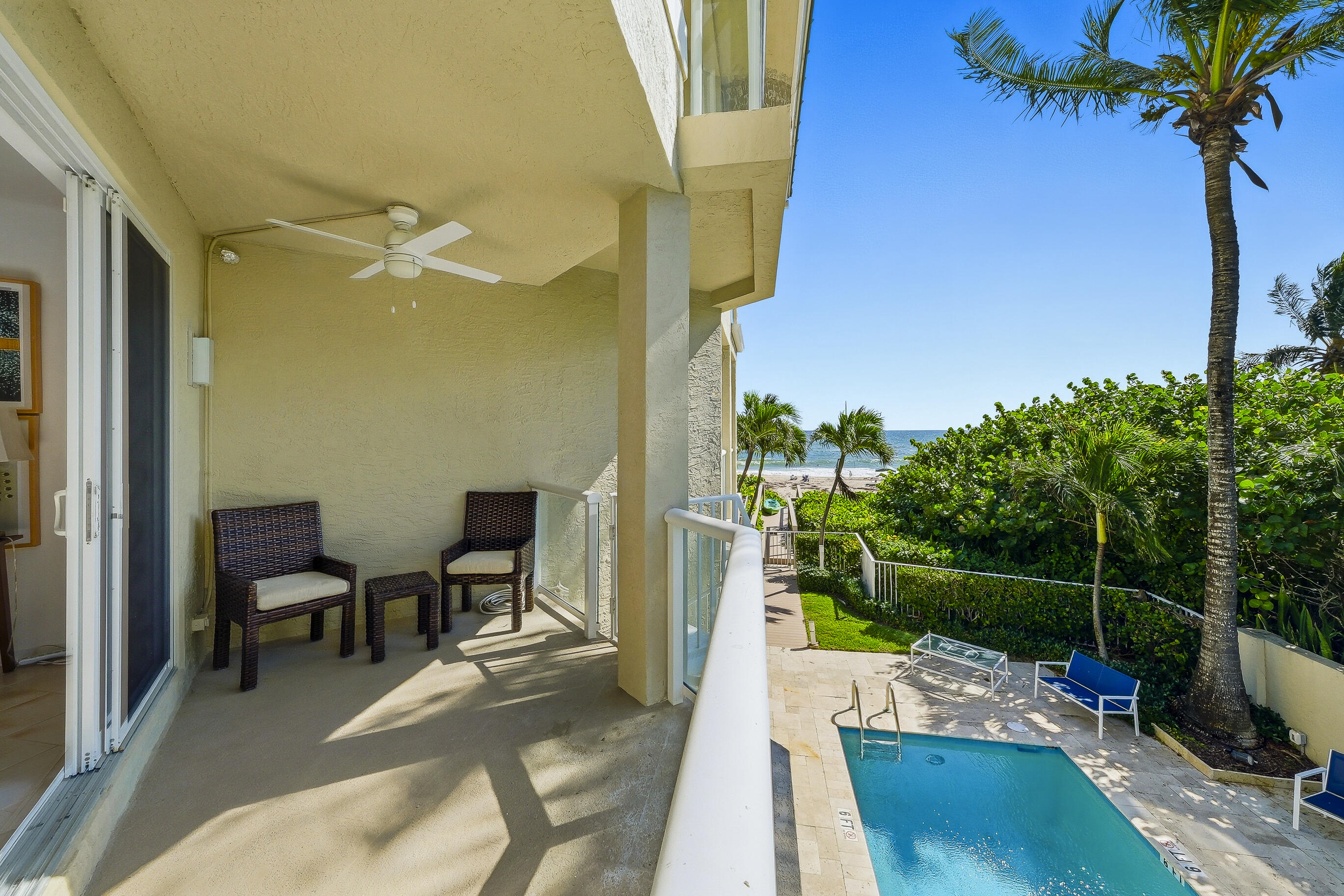 4535 Coquina Road Ocean Ridge, FL 33435 - Photo 12 of 45 a view of a balcony with chair and potted plants