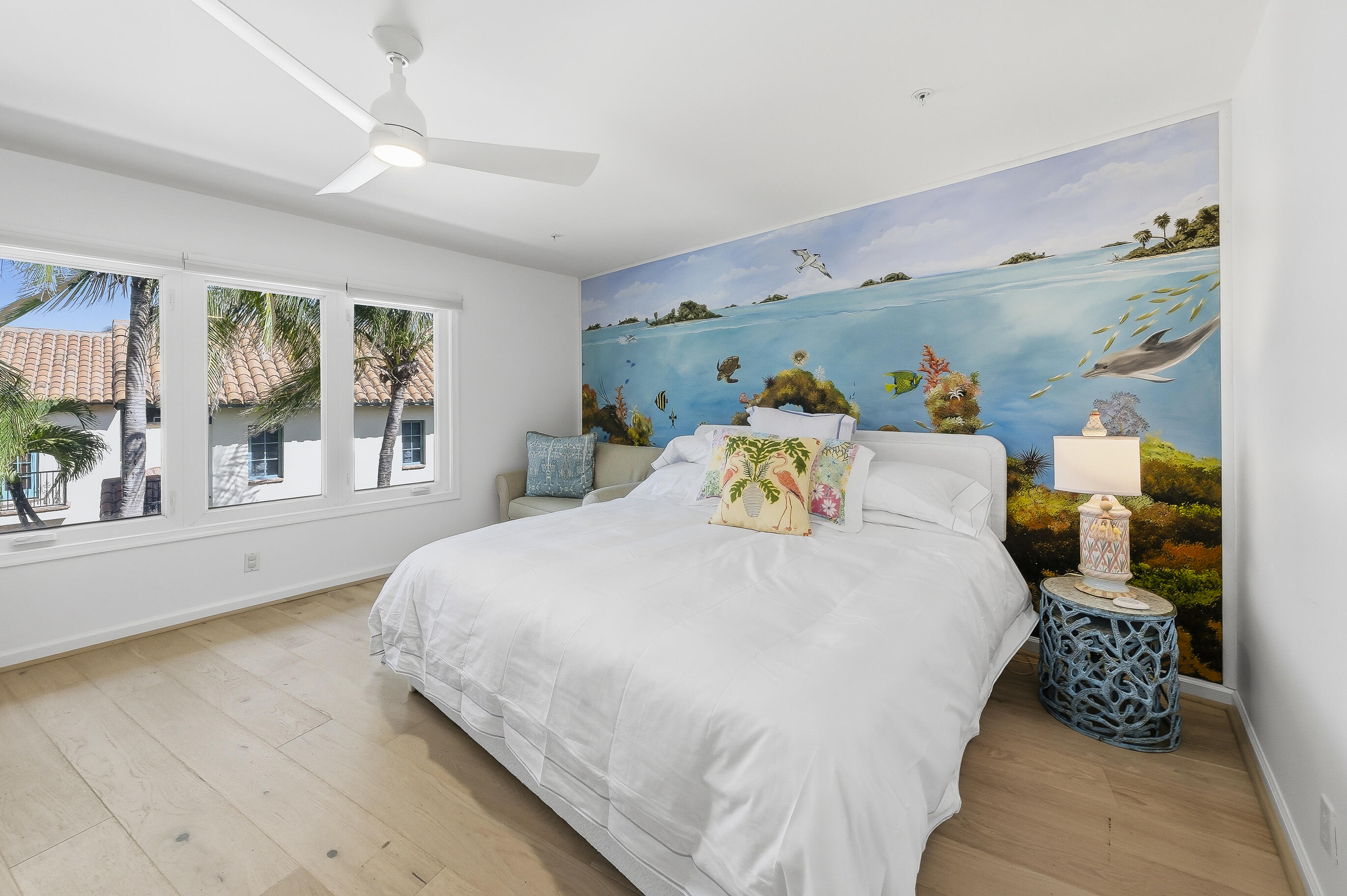 4535 Coquina Road Ocean Ridge, FL 33435 - Photo 22 of 45 a bedroom with a bed and large windows