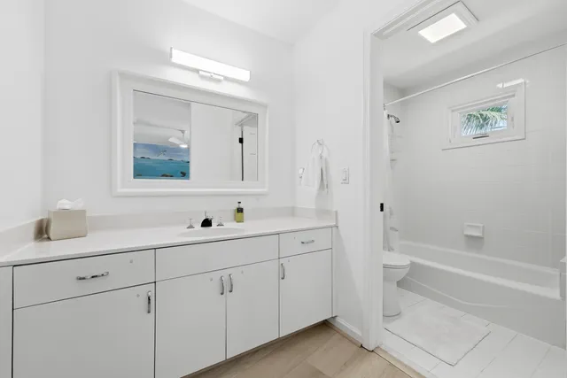 a white toilet sitting next to a bath tub