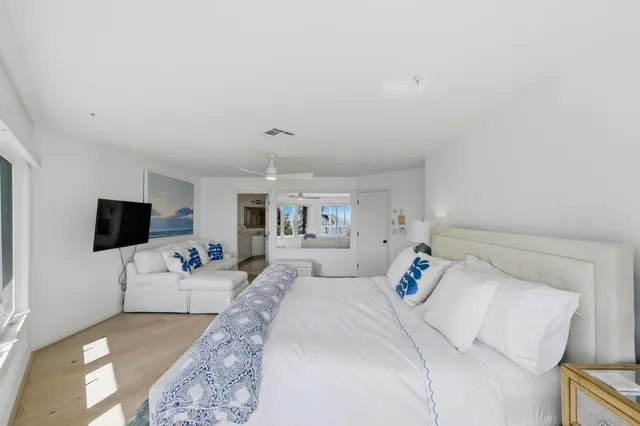 a bedroom with furniture and wooden floor