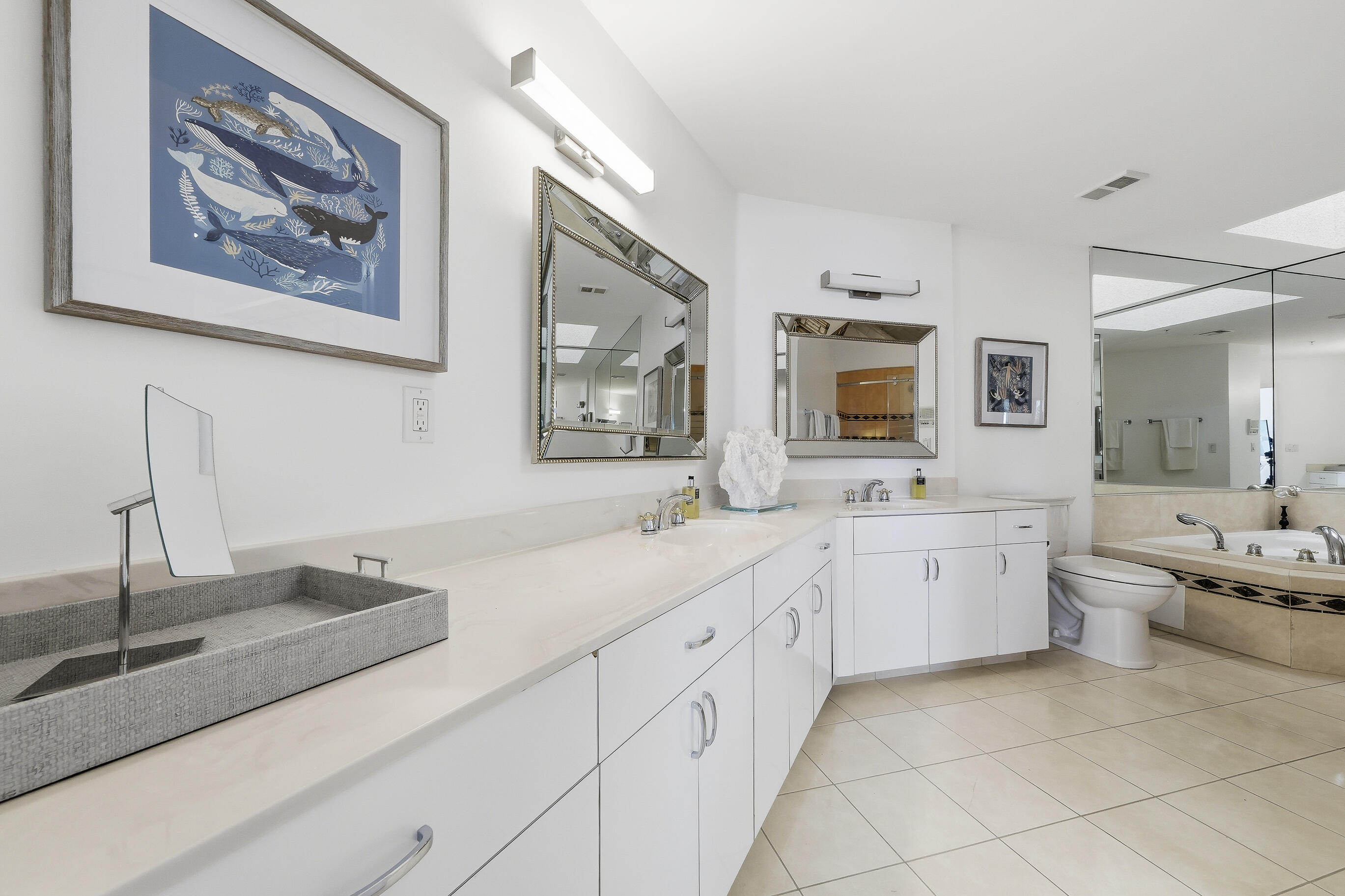 4535 Coquina Road Ocean Ridge, FL 33435 - Photo 30 of 45 a spacious en suite bathroom with a granite countertop double vanity sink a bathtub and window