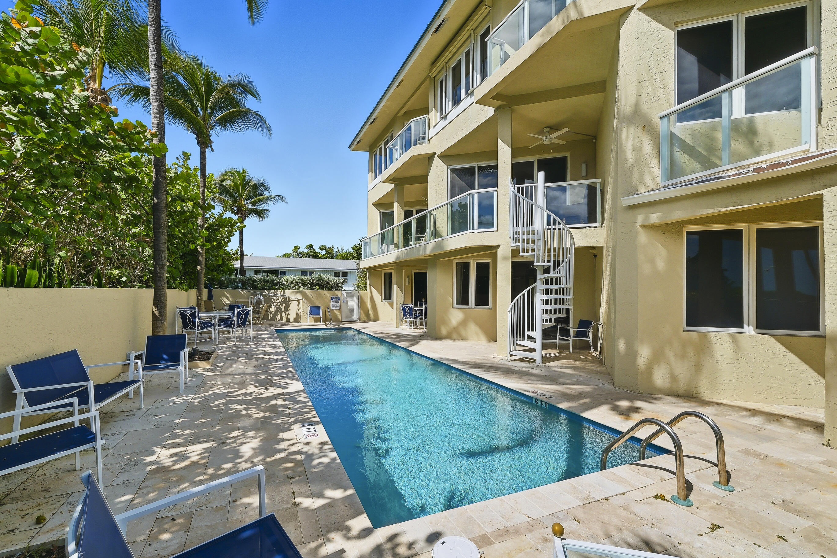 4535 Coquina Road Ocean Ridge, FL 33435 - Photo 34 of 45 a view of a house with pool and chairs