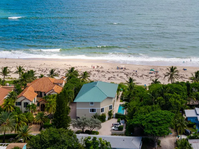 a aerial view of a house with a yard and lake view