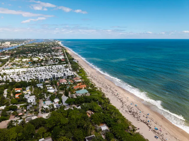 a view of a house with a yard and potted plants