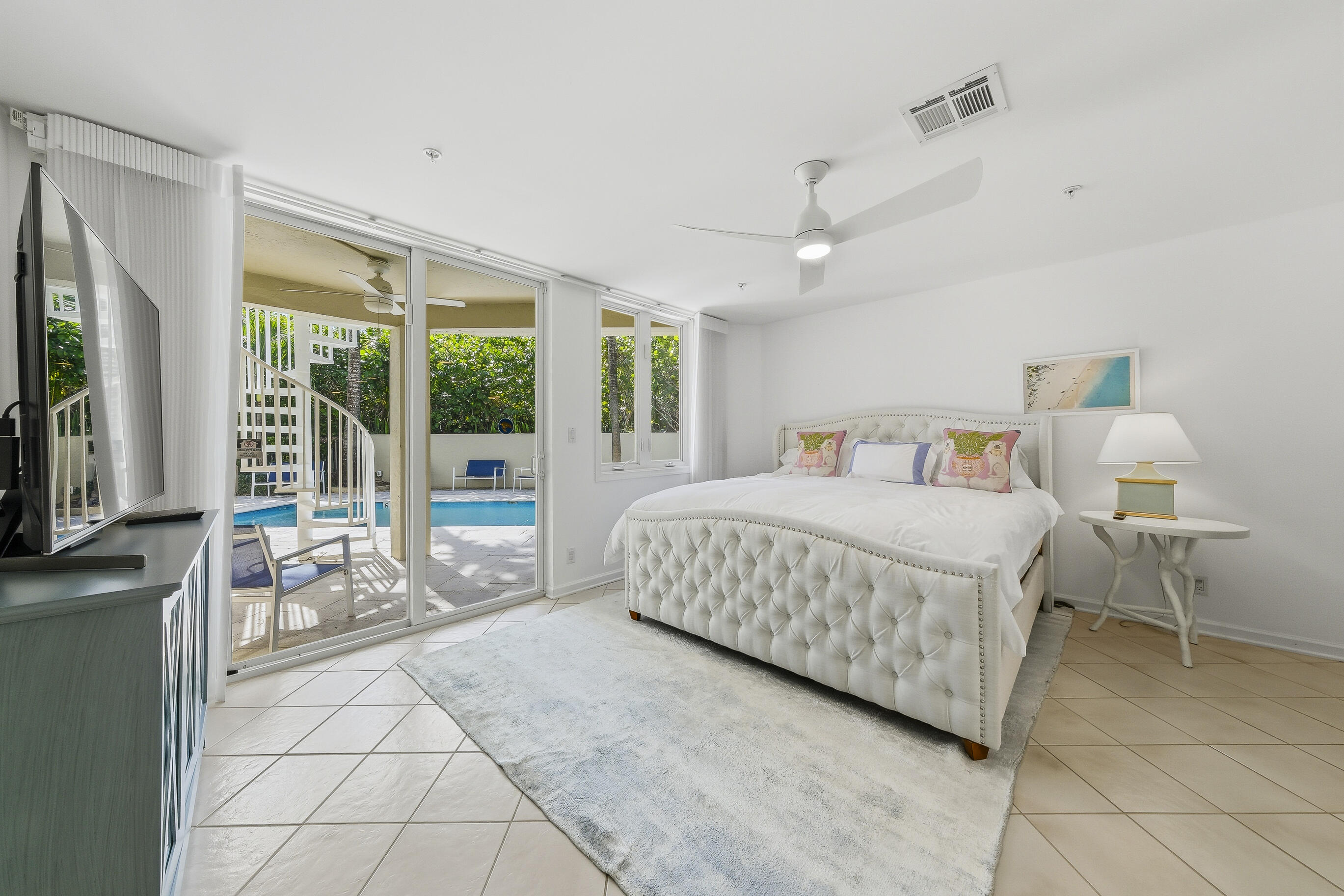 4535 Coquina Road Ocean Ridge, FL 33435 - Photo 5 of 45 a bedroom with a bed and large windows