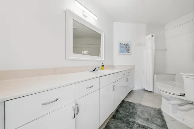 a spacious bathroom with 2 sink and a bathtub