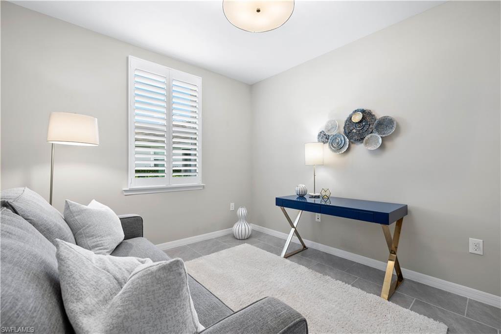 14558 Edgewater Circle Naples, FL 34114 - Photo 17 of 40 a bedroom with a bed and a window